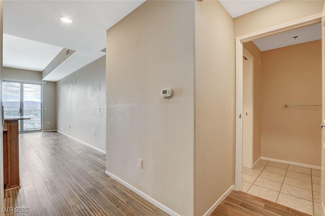 corridor featuring baseboards