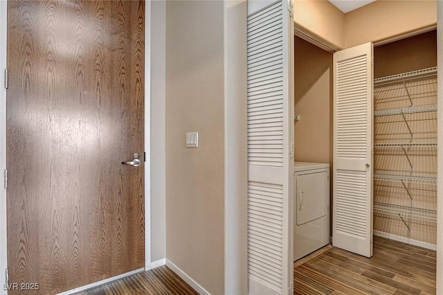 laundry room with laundry area, baseboards, washer / clothes dryer, and wood finished floors