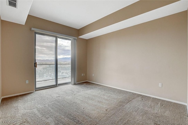 empty room with baseboards, carpet, and visible vents