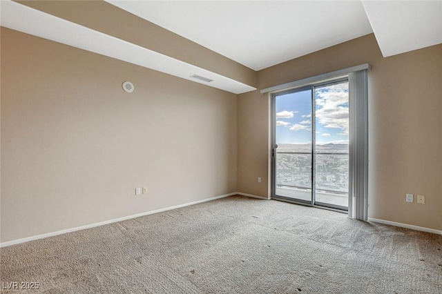 unfurnished room with carpet flooring, baseboards, and visible vents