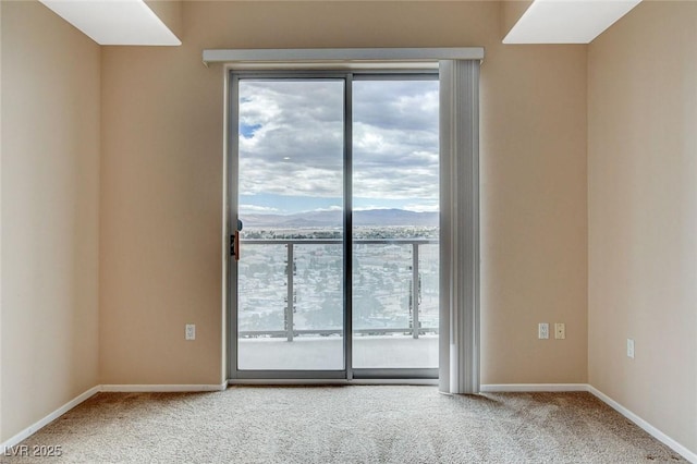 carpeted spare room with baseboards and a wealth of natural light