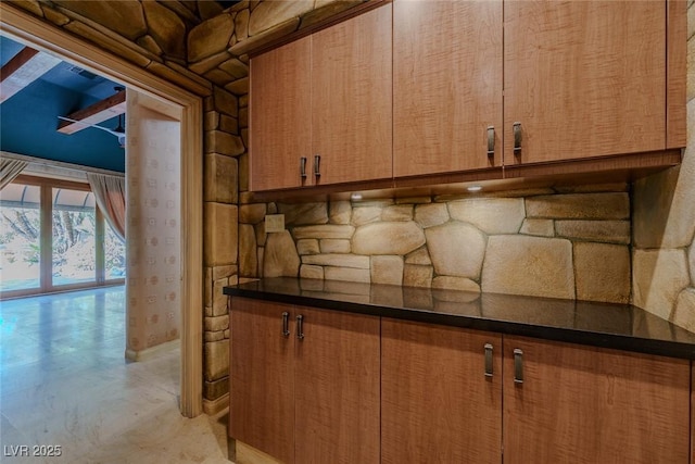8199 Pinnacle Peak Ave, Las Vegas, NV 89113 - kitchen with brown cabinets, dark countertops, and baseboards