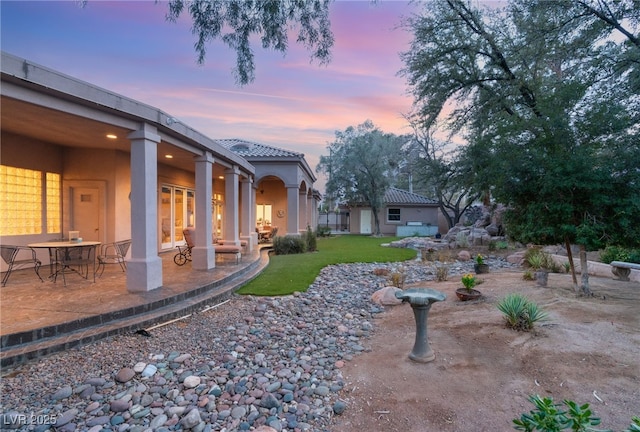 1234 Campbell Dr, Las Vegas, NV 89102 - yard at dusk with a patio