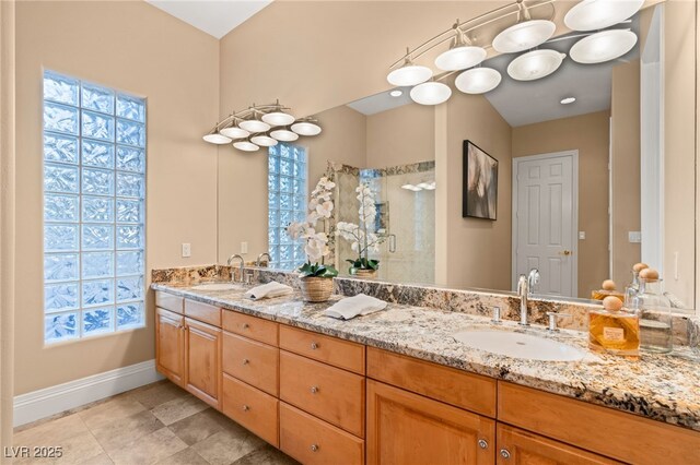 1234 Campbell Dr, Las Vegas, NV 89102 - bathroom with baseboards, a healthy amount of sunlight, a sink, and a stall shower
