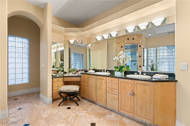 1234 Campbell Dr, Las Vegas, NV 89102 - bathroom featuring a shower, double vanity, baseboards, and a sink