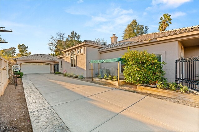 1234 Campbell Dr, Las Vegas, NV 89102 - view of front facade featuring stucco siding, a tile roof, fence, and a chimney