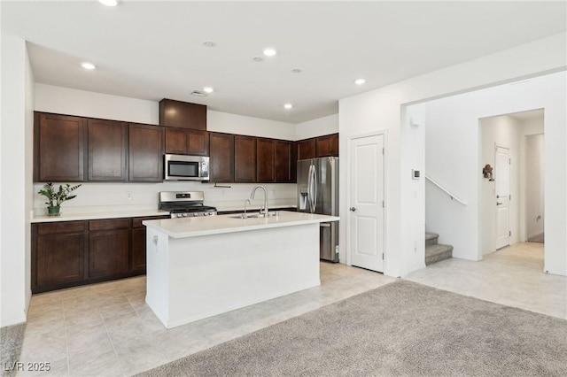 2877 Sweeping Palm Rd, North Las Vegas, NV 89086 - kitchen featuring stainless steel appliances, a sink, light countertops, dark brown cabinetry, and recessed lighting