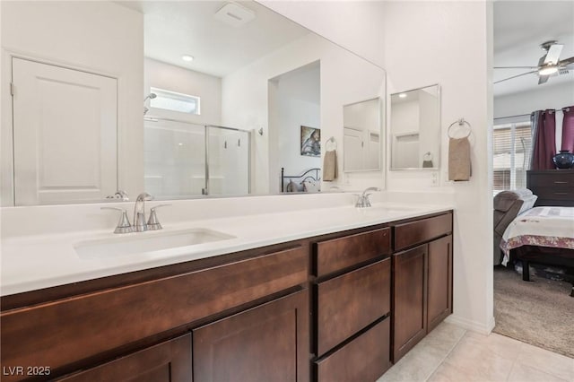 2877 Sweeping Palm Rd, North Las Vegas, NV 89086 - ensuite bathroom with double vanity, a shower stall, a ceiling fan, and tile patterned flooring