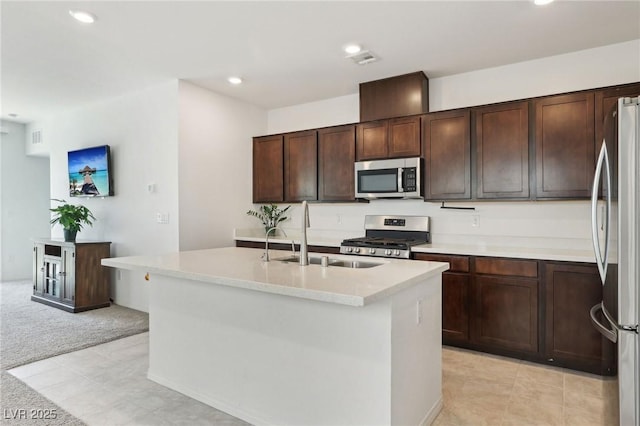 2877 Sweeping Palm Rd, North Las Vegas, NV 89086 - kitchen with stainless steel appliances, a sink, recessed lighting, light countertops, and light colored carpet