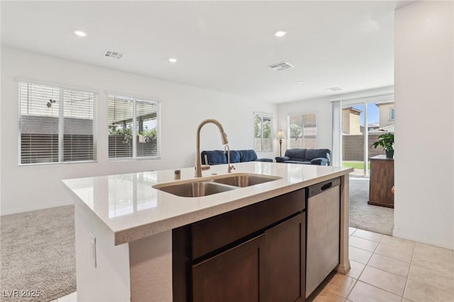 2877 Sweeping Palm Rd, North Las Vegas, NV 89086 - kitchen with stainless steel dishwasher, light carpet, a sink, open floor plan, and dark brown cabinetry