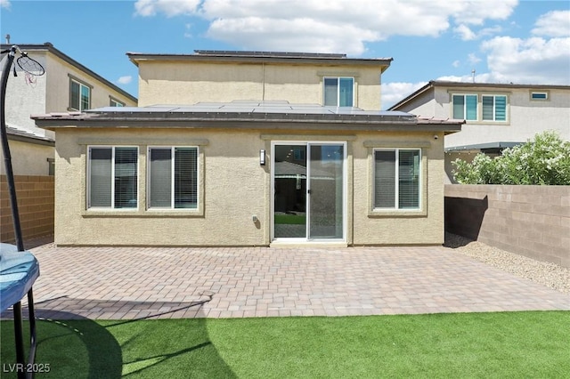 2877 Sweeping Palm Rd, North Las Vegas, NV 89086 - rear view of property featuring roof mounted solar panels, a patio, and stucco siding