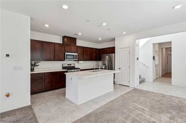 2877 Sweeping Palm Rd, North Las Vegas, NV 89086 - kitchen featuring stainless steel appliances, a sink, light countertops, recessed lighting, and an island with sink