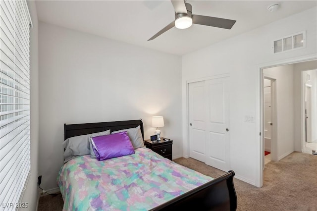 2877 Sweeping Palm Rd, North Las Vegas, NV 89086 - bedroom with light carpet, a closet, a ceiling fan, and baseboards