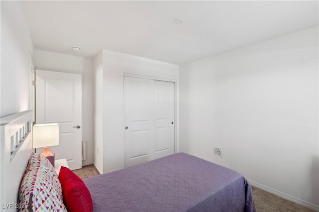 2877 Sweeping Palm Rd, North Las Vegas, NV 89086 - bedroom with light colored carpet, a closet, and baseboards