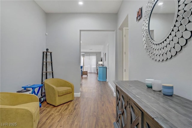 hall with baseboards, wood finished floors, and recessed lighting