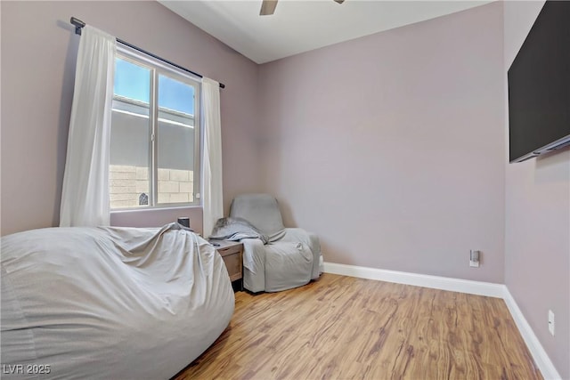 sitting room with ceiling fan, baseboards, and wood finished floors