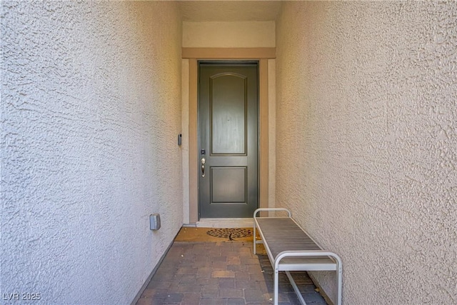 property entrance featuring stucco siding