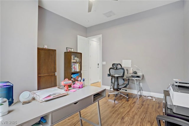 office area with baseboards, a ceiling fan, wood finished floors, and visible vents