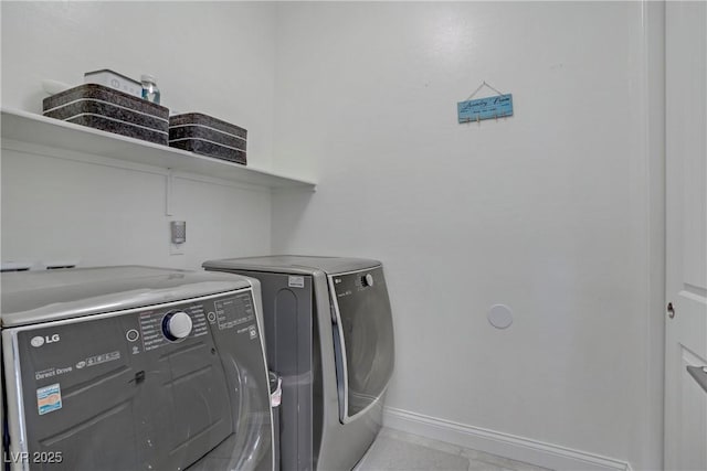 laundry area featuring baseboards, separate washer and dryer, and laundry area