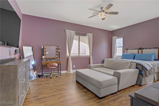 bedroom featuring light wood-type flooring, baseboards, and ceiling fan