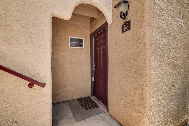 property entrance featuring stucco siding