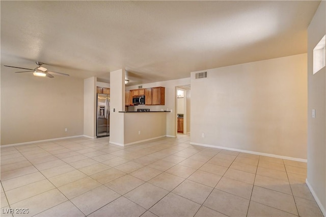 unfurnished living room featuring light tile patterned floors, visible vents, ceiling fan, and baseboards