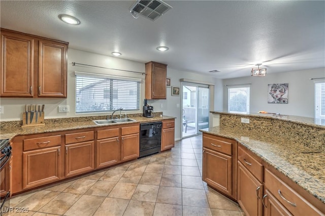 6546 American Flower St, Las Vegas, NV 89148 - kitchen featuring black appliances, a sink, brown cabinets, light stone countertops, and light tile patterned floors