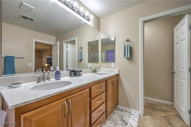 6546 American Flower St, Las Vegas, NV 89148 - bathroom with double vanity and a shower with shower door