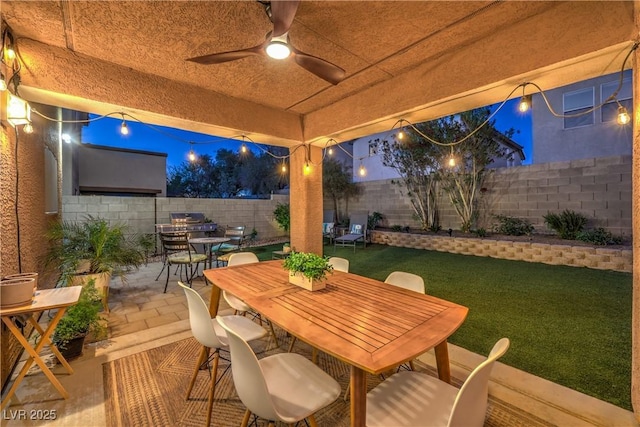 6546 American Flower St, Las Vegas, NV 89148 - patio at night with outdoor dining space and ceiling fan