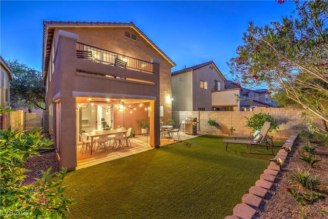 6546 American Flower St, Las Vegas, NV 89148 - rear view of house with a balcony, a patio area, and stucco siding