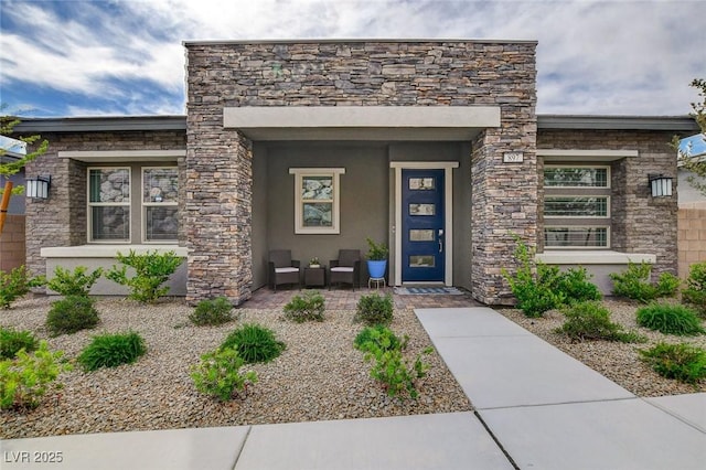897 Woodburn Ln, Las Vegas, NV 89138 - property entrance featuring stone siding, stucco siding, and covered porch