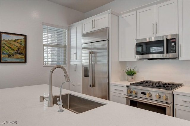 897 Woodburn Ln, Las Vegas, NV 89138 - kitchen featuring premium appliances, light countertops, and white cabinets