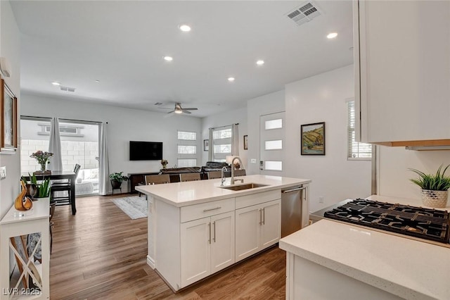 897 Woodburn Ln, Las Vegas, NV 89138 - kitchen featuring stainless steel dishwasher, light countertops, a ceiling fan, white cabinets, and recessed lighting