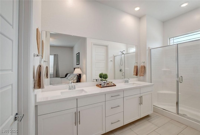 897 Woodburn Ln, Las Vegas, NV 89138 - bathroom with double vanity, a shower stall, tile patterned flooring, connected bathroom, and recessed lighting