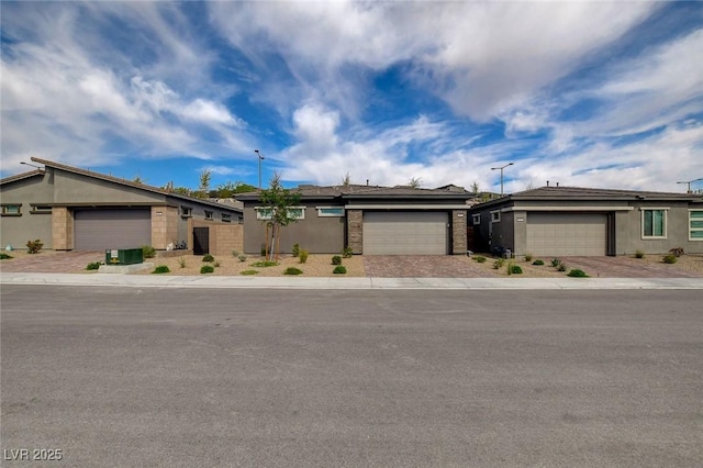 897 Woodburn Ln, Las Vegas, NV 89138 - ranch-style home with a garage, driveway, and stucco siding