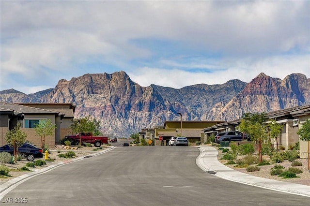 897 Woodburn Ln, Las Vegas, NV 89138 - view of asphalt street featuring a mountain view, sidewalks, and curbs