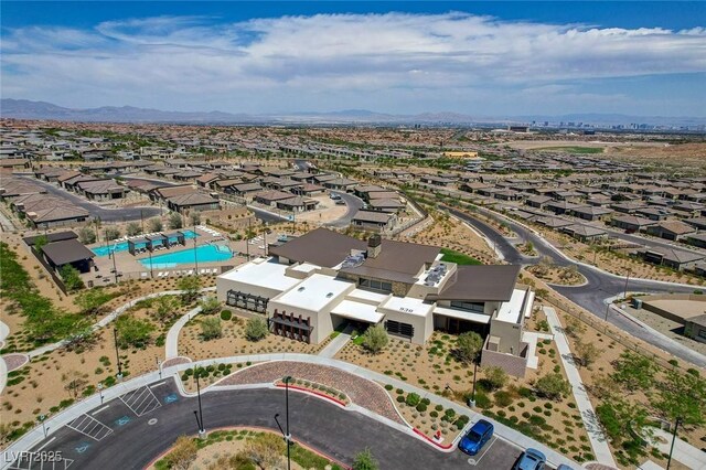 897 Woodburn Ln, Las Vegas, NV 89138 - aerial perspective of suburban area featuring a pool and a mountainous background