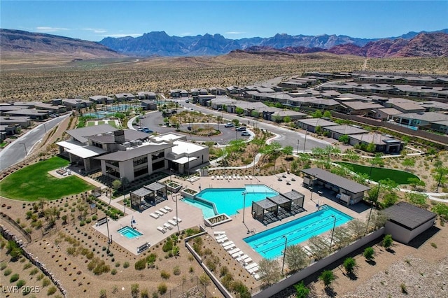 897 Woodburn Ln, Las Vegas, NV 89138 - aerial perspective of suburban area with a pool area and mountains