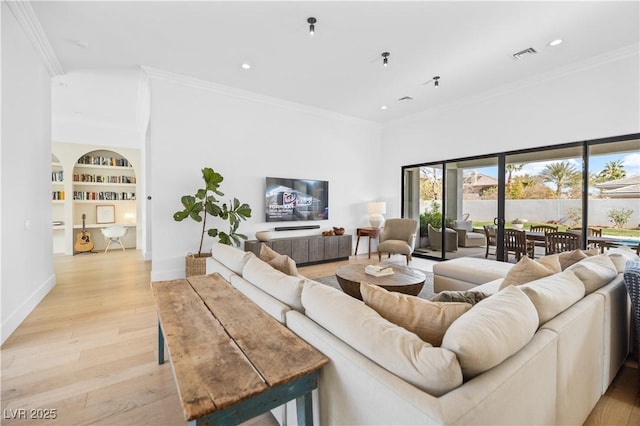 10969 Tranquil Waters Ct, Las Vegas, NV 89135 - living area with light wood finished floors, built in shelves, crown molding, recessed lighting, and baseboards