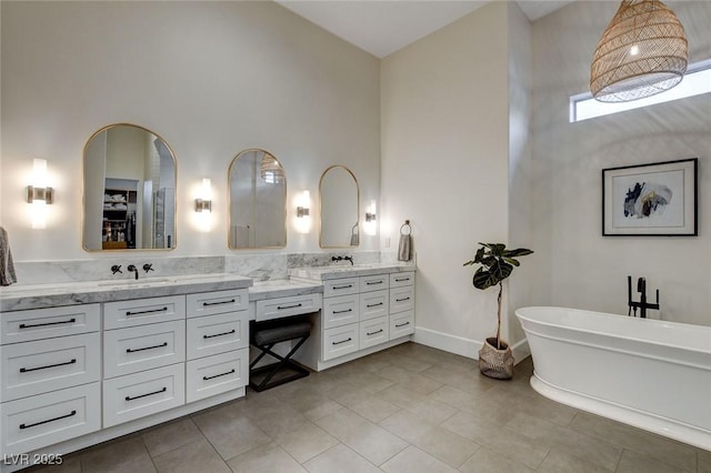 10969 Tranquil Waters Ct, Las Vegas, NV 89135 - full bath featuring vanity, a freestanding bath, a high ceiling, and tile patterned flooring