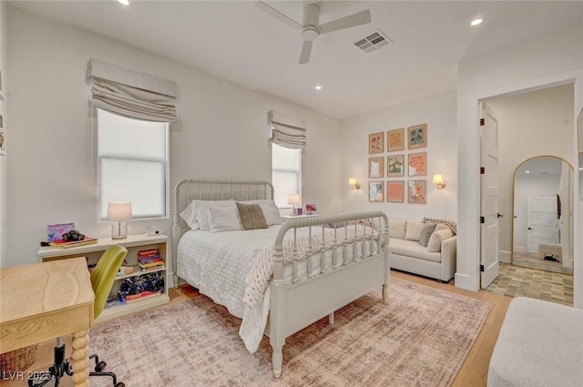 10969 Tranquil Waters Ct, Las Vegas, NV 89135 - bedroom with light wood-type flooring, recessed lighting, a ceiling fan, connected bathroom, and arched walkways