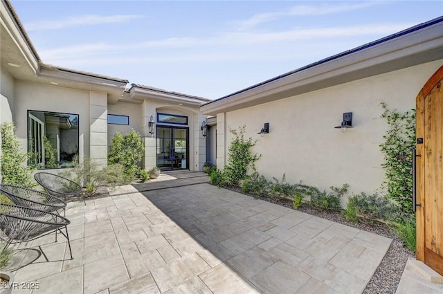 10969 Tranquil Waters Ct, Las Vegas, NV 89135 - view of exterior entry featuring stucco siding and a patio area