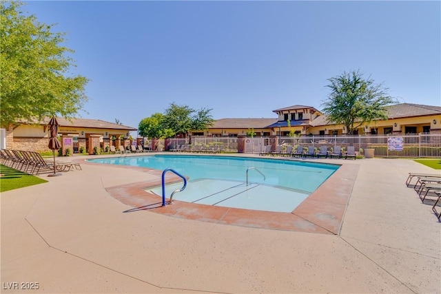 community pool featuring a patio and fence