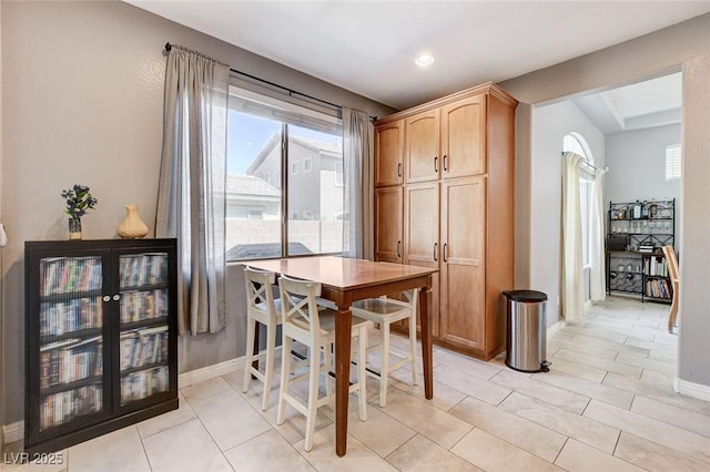 dining room with plenty of natural light, baseboards, light tile patterned floors, and recessed lighting