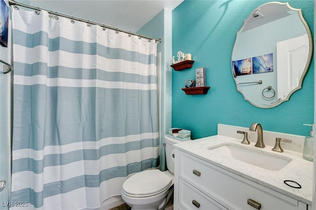bathroom with toilet, vanity, and a shower with curtain
