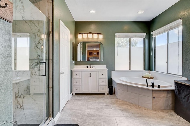 full bath with healthy amount of natural light, a marble finish shower, and a bath