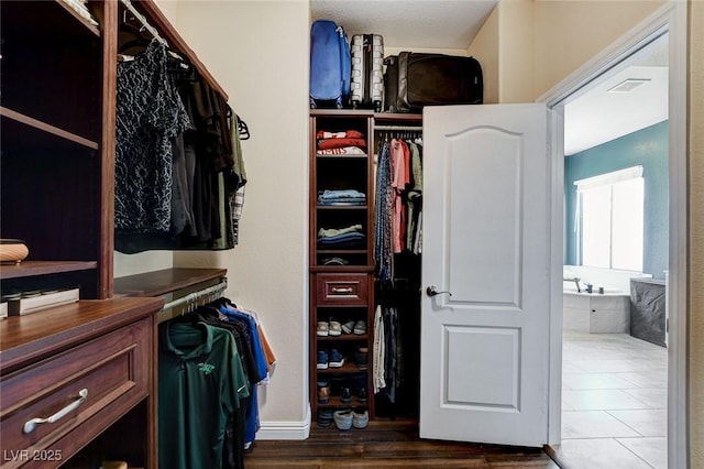 walk in closet featuring wood finished floors