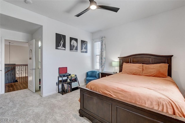 bedroom featuring light colored carpet, ceiling fan, and baseboards