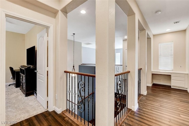 corridor featuring an upstairs landing, wood finished floors, and baseboards