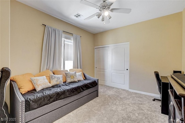 living area featuring ceiling fan, carpet flooring, and baseboards